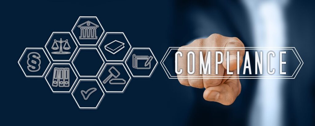 Finger pointing to word "Compliance" and array of icons relating to medical, legal, and other regulations - WebGrit