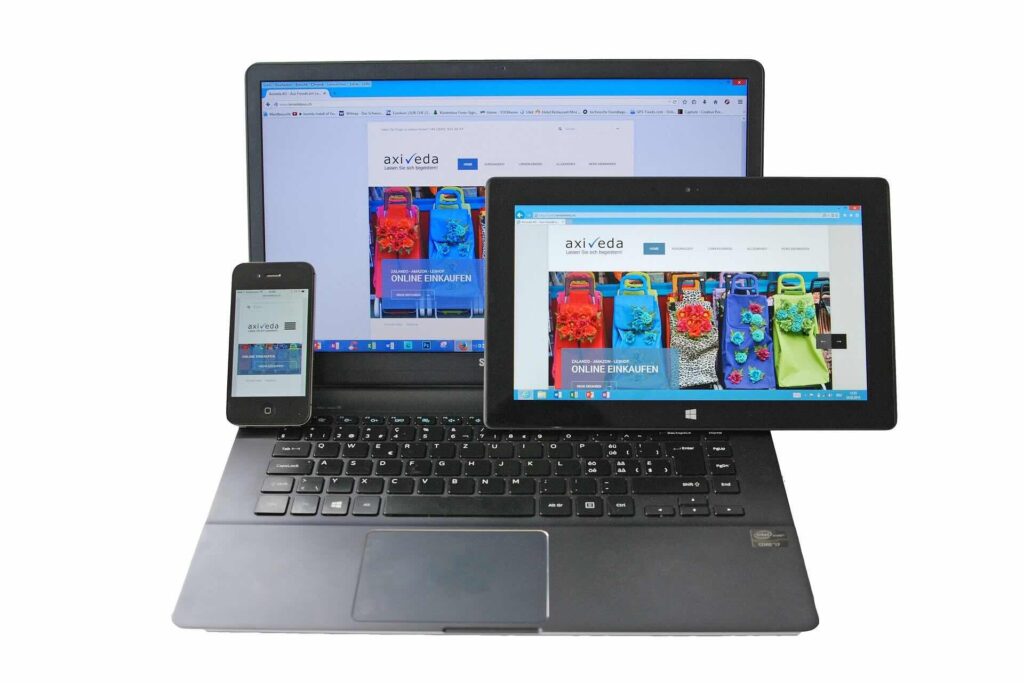 Colorful purses in online store displayed on cell phone, tablet, and laptop screens - WebGrit