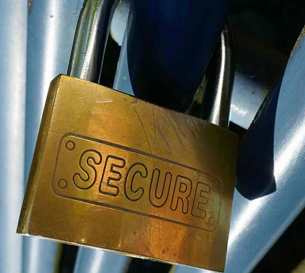 Big, golden padlock with words "Secure" engraved against blue metal background - WebGrit