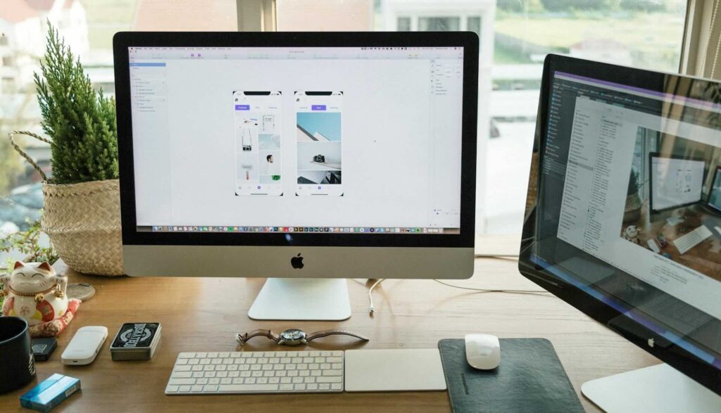 2 computer monitor screens showing website design elements - WebGrit