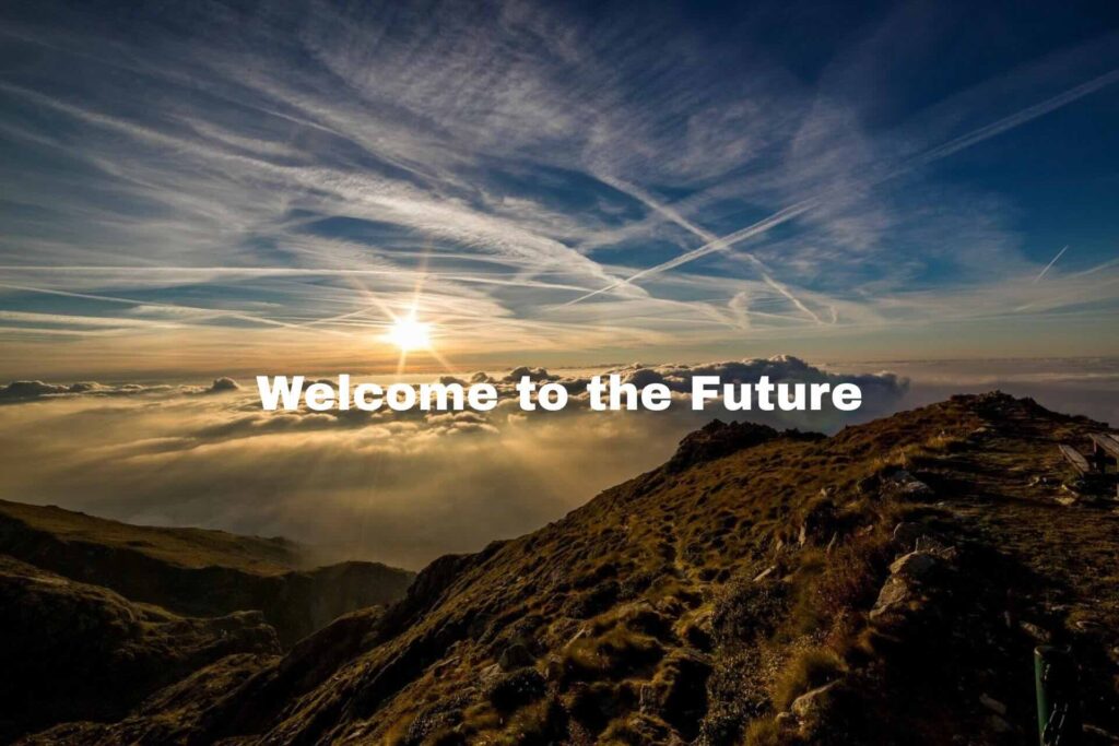 Welcome to the future text overlay, mountain top at sunrise, clouds on horizon - WebGrit